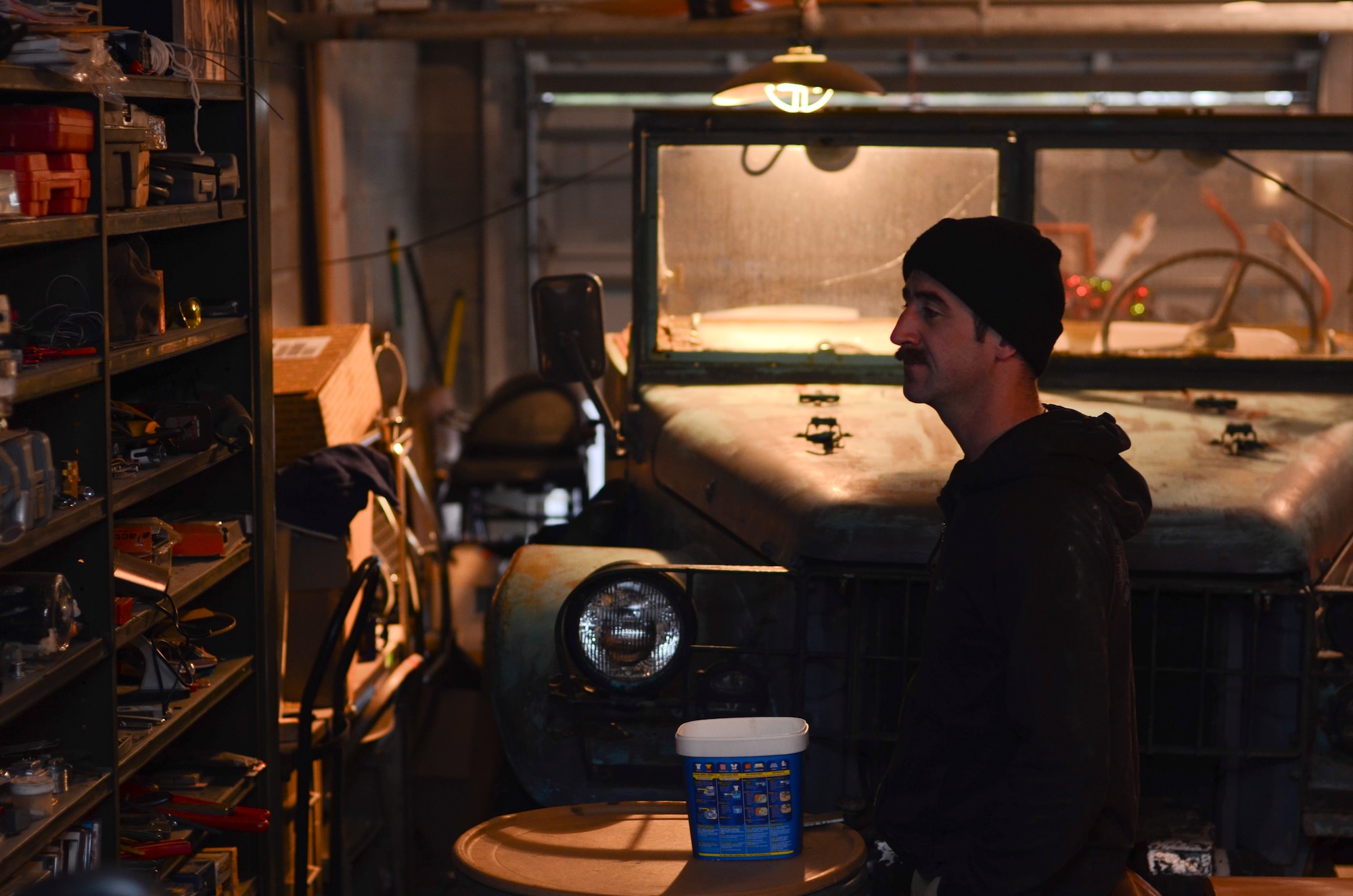 Maj. Nick Noreus, 8th Special Operations Squadron CV-22 Osprey pilot, looks through a wall of equipment in Destin, Fla., Jan. 24, 2014. Noreus's projects are housed in a storage area and include a race car that he built, gyro-plane ultralight, and another two-passenger gyroplane he's building. (U.S. Air Force photo/Staff Sgt. John Bainter)