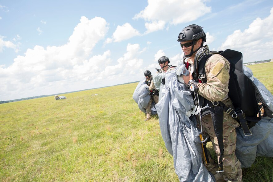 U.S. Air Force Senior Airman Roman Ramirez, 38th Rescue Squadron pararescueman, carries his equipment after an HC-130J Combat King II jump at Moody Air Force Base, Ga., June 19, 2014. The jump was to educate cadets on the 38th RQS training environment during the combat rescue officer shadow and orientation week. (U.S. Air Force photo by Airman Dillian Bamman/Released)