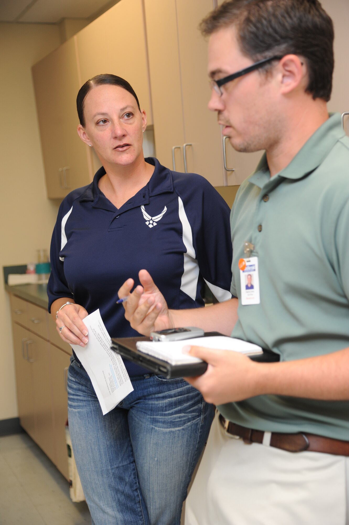 Master Sgt. Laurie Holmes, 81st Training Wing and Top III president, is interviewed by Patrick Ochs, The Sun Herald staff writer, on the fundraising and donation efforts the organization committed to the Back Bay Mission in Biloxi, Miss., June 18, 2014. The Top III raised more than $1,500 for the Back Bay Mission “Summer Food Program” which was used to purchase a one-week supply of food for 50 families.   (U.S. Air Force photo by Kemberly Groue)