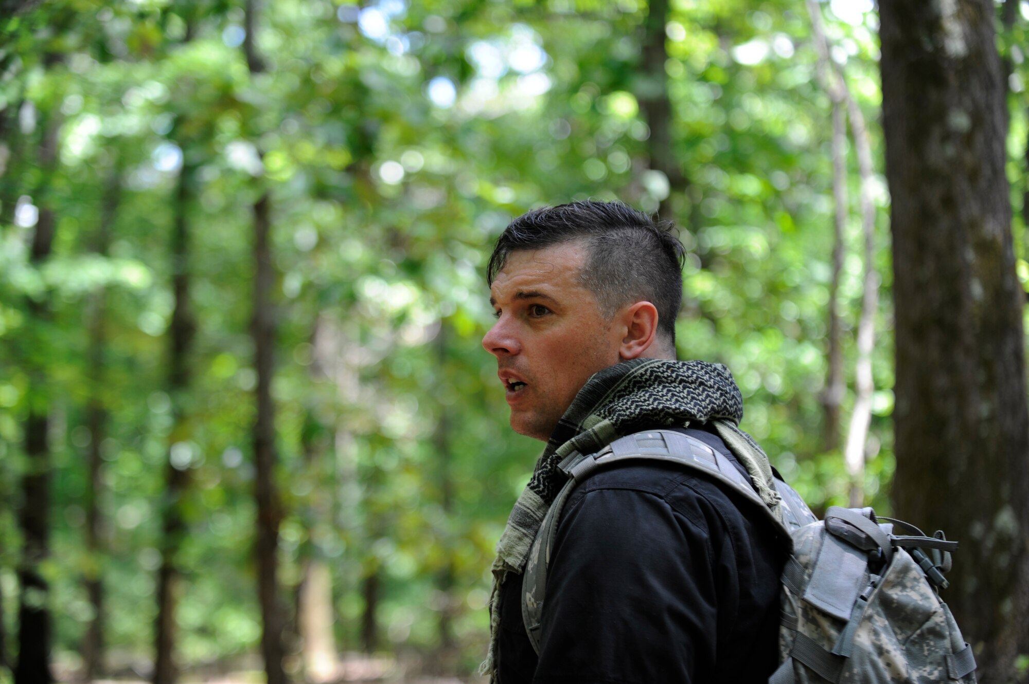 Sgt. 1st Class Victor Markovich, Defense Threat Reduction Agency interpreter and sensor operator, listens for SERE students to give away their position while role playing as an insurgent  in Gambrills, Md.,  June 6, 2014.  The training focuses on evading capture, survival skills, and the military code of conduct. SERE is mandatory for aircrew and personnel required to maintain Code of Conduct Continuation Training. Skills gained at SERE are tailored for specific aircraft, missions and deployed locations.  (U.S. Air Force photo/Senior Airman Mariah Haddenham )