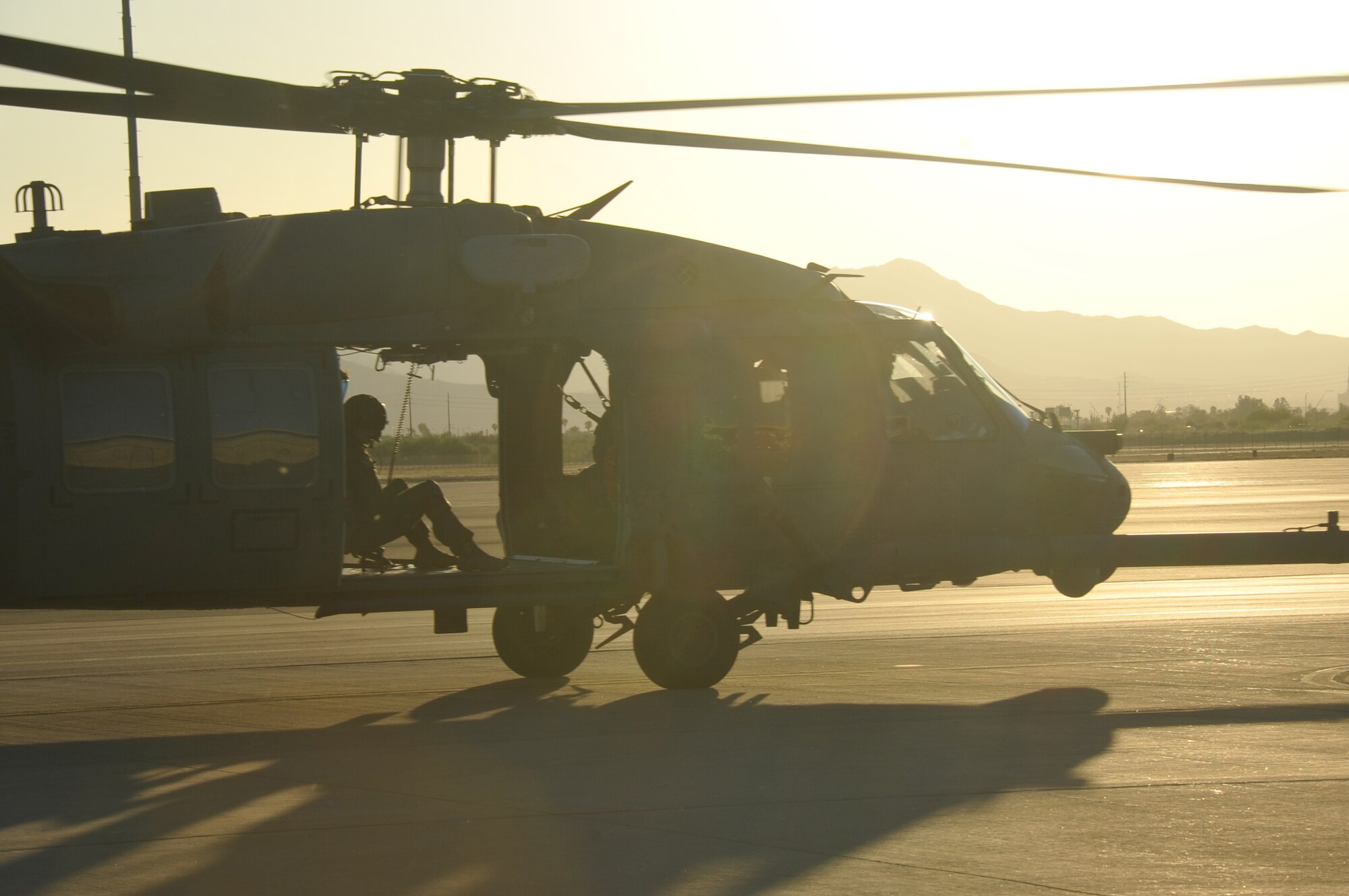 An HH-60G Pave Hawk prepares to begin an air-refueling exercise as the sun sets on Davis-Monthan Air Force Base, Ariz., June 19, 2014. The primary mission of the HH-60G is to conduct day or night combat-search-and-rescue operations into hostile environments to recover downed aircrew or other isolated personnel during war. (U.S. Air Force photo/Senior Airman Natasha Dowridge)