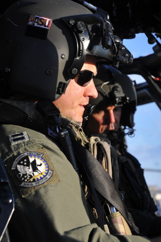 Capt. Brent Watts (left), an HH-60G Pave Hawk helicopter pilot with the 305th Rescue Squadron, Davis-Monthan Air Force Base, Ariz., patiently waits as his crew prepares the aircraft for take-off June 19, 2014. Watts and his co-pilot, Maj. Dave Gonzales (right), will be flying the Pave Hawk on an air-refueling exercise. (U.S. Air Force photo/Senior Airman Natasha Dowridge)