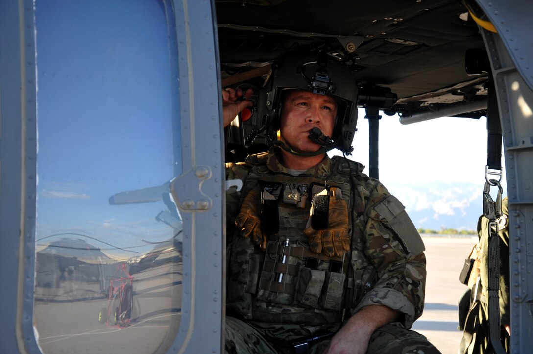 Tech. Sgt. Anthony Truesdale, an HH-60G Pave Hawk special mission aviator with the 305th Rescue Squadron, Davis-Monthan Air Force Base, Ariz., checks a cord on his helmet prior to an air-refueling exercise June 19, 2014. Recently, the flight engineer and aerial gunner careers were merged to make the special missions aviator career field. (U.S. Air Force/Senior Airman Natasha Dowridge)