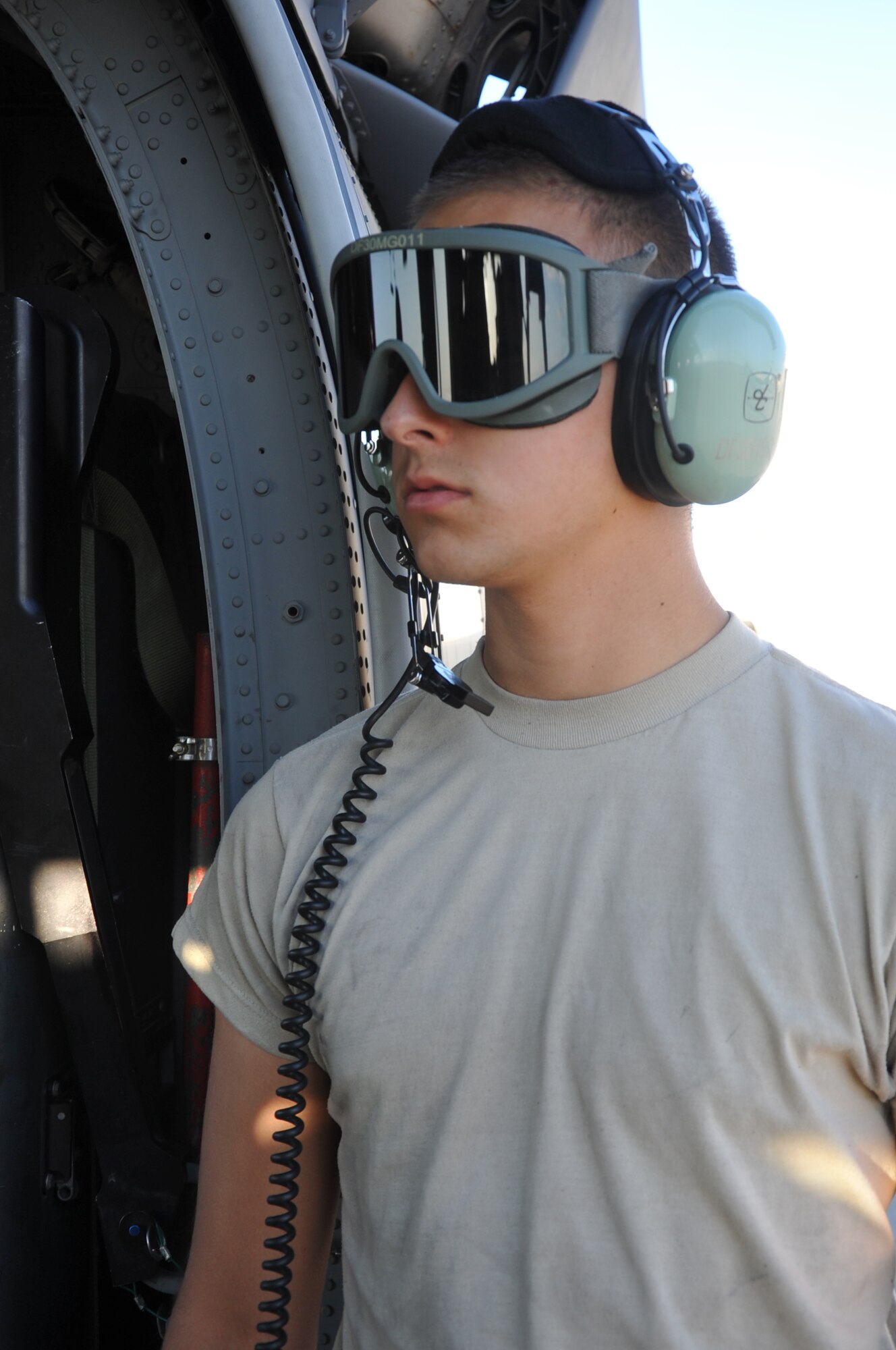 Airman 1st Class Michael Kramer, an HH-60G Pave Hawk tactical aircraft maintainer with the 943rd Rescue Group, Davis-Monthan Air Force Base, Ariz., stays protected with eye gear and double ear protection while prepping an HH-60G for an exercise June 19, 2014.  Tactical aircraft maintainers, more commonly known as "crew chiefs," coordinate the aircraft's maintenance and call in specialists when a problem is found. (U.S. Air Force photo/Senior Airman Natasha Dowridge)