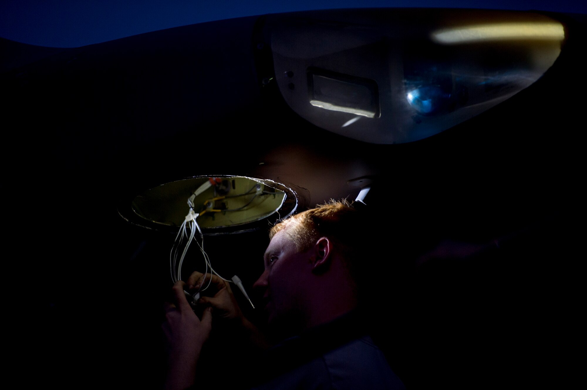 U.S. Air Force Senior Airman Chase Decker, 5th Expeditionary Aircraft Maintenance Squadron electrician changes the wires located in the wing of a C-17 Globemaster III. Decker is deployed to The Rock from 860th AMXS in support of Operation Enduring Freedom and is a native of Kennewick, Washington. (U.S. Air Force photo by Staff Sgt. Jeremy Bowcock)