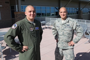 Senior Airmen Evan and Adam Van Horn stand outside the Air Reserve Personnel Center headquarters building June 17, 2014. Members at the Air Reserve Personnel Center have been seeing double since Senior Airmen Evan and Adam Van Horn were assigned here. Although the twins are fraternal, it’s difficult to tell them apart. Their journey began in May when Evan began working as a points management agent on Reserve Personnel Appropriation orders here. (U.S. Air Force photo/Tech. Sgt. Rob Hazelett)