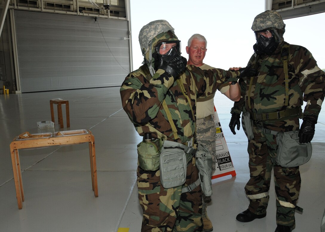 U.S. Air Force Master Sgt. Thomas Thornton gives instructions on how to perform a body sweep using a M295 decontamination mitt during CBRNE survival skills training on the Mississippi Combat Readiness Training Center in Gulfport, Miss., June 18, 2014. Thornton trained airmen on skills needed during chemical, biological and nuclear attacks. (U.S. Air Force photo by Senior Airman Jessica Fielder/Released)