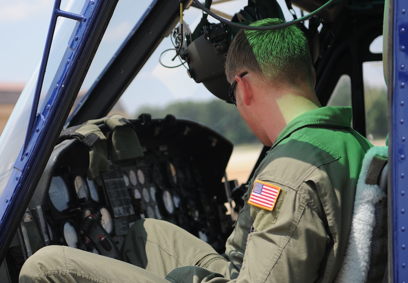 Staff Sgt. Mark Cornett, 1st Helicopter Squadron special missions aviator instructor, checks the instruments on a UH-1N Huey helicopter on Joint Base Andrews, Md., June 17, 2014. (U.S. Air Force photo/Airman 1st Class Ryan J. Sonnier)