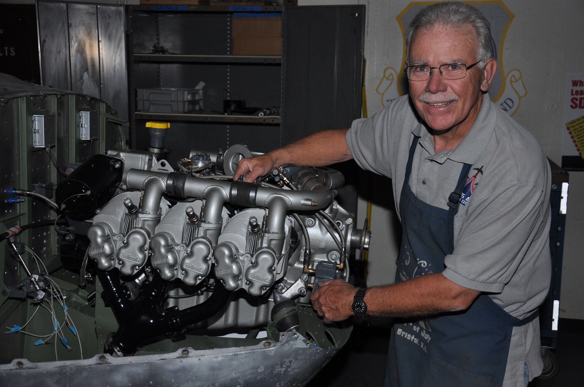 John Markley, Travis Heritage Center restoration volunteer, displays the engine of a O-2 Super Skymaster June 17, 2014, at the Heritage Center. The Travis Heritage Center has one of the largest collections of military aircraft on the West Coast. (U.S. Air Force photo/Staff Sgt. Christopher Carranza)
