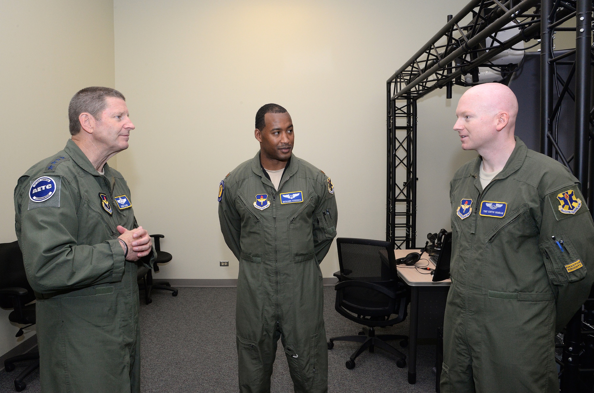 Gen. Robin Rand, Air Education and Training Command commander, Joint Base San Antonio-Randolph, Texas receives a briefing about the T-6 simulator at the 558th Flying Training Squadron, JBSA-Randolph, from Maj. Michawn, (center), an instructor pilot and Tech. Sgt. Curtis Sondag, a sensor operator instructor during Gen. Rand’s site visit to the 12th Flying Training Wing, JBSA-Randolph, June 13, 2014.  (U.S. Air Force photo by Johnny Saldivar)
