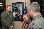 Lt. Col. Todd A. Ernst, 39th Flying Training Squadron, Joint Base San Antonio-Randolph, Texas, discusses key differences in Reserve Component survivor benefits with Gen. Robin Rand, Air Education and Training Command commander, by the portrait of Maj. Peter “Oly” Jahns, during a site visit of the 12th Flying Training Wing, June 13, 2014.   Maj. Jahns perished in a T-38C aircraft accident at Randolph AFB on March 19, 2003.  The 39th FTS headquarters building was memorialized as “Jahns Hall” in May 2013.   (U.S. Air Force photo by Johnny Saldivar)