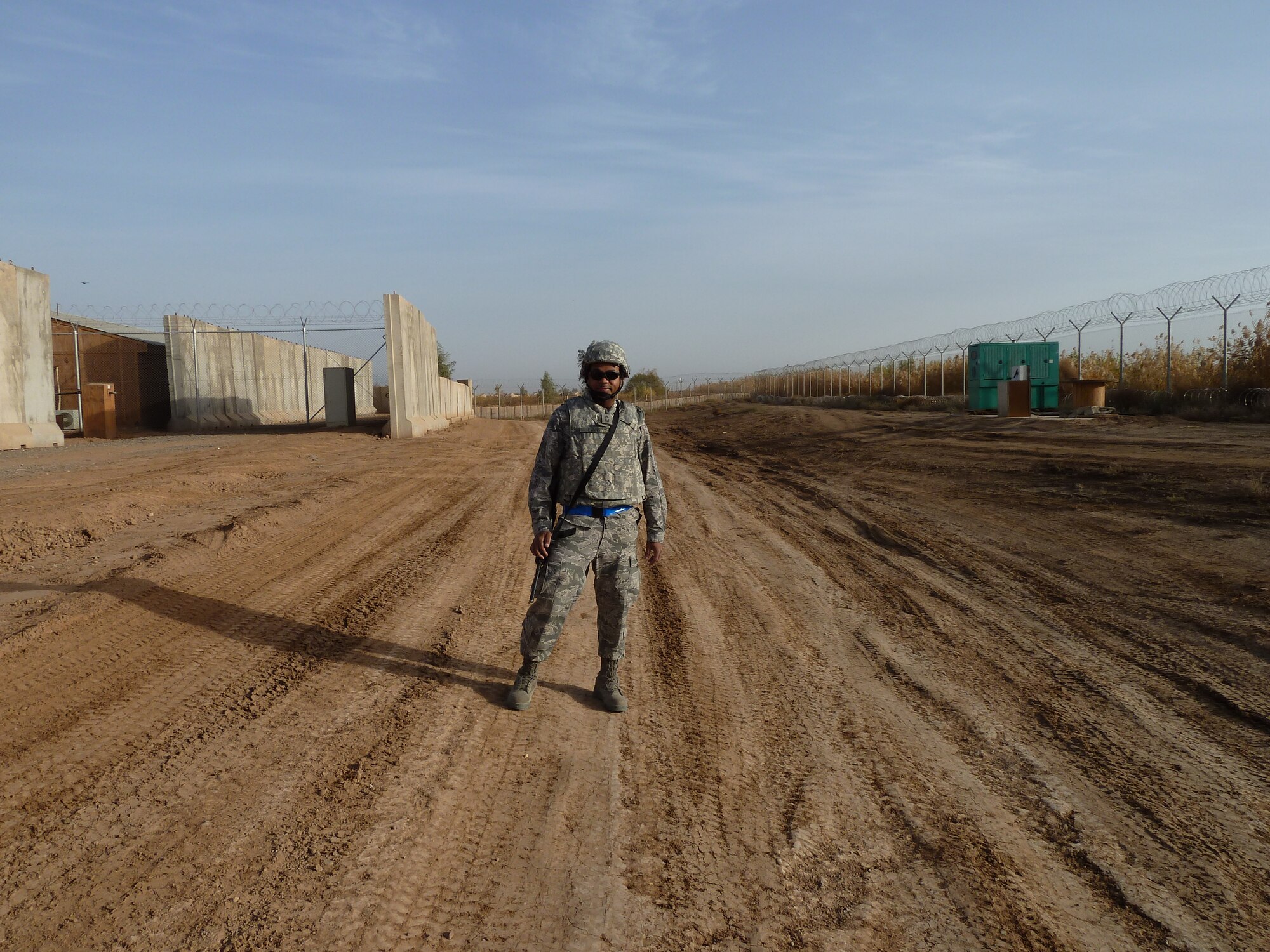Chief Master Sgt. Alfonzo Evans stands on an unpaved road in 2011 during his deployment to Iraq. The then-senior-master-sergeant experienced the loss of his brother while deployed. (courtesy photo)
