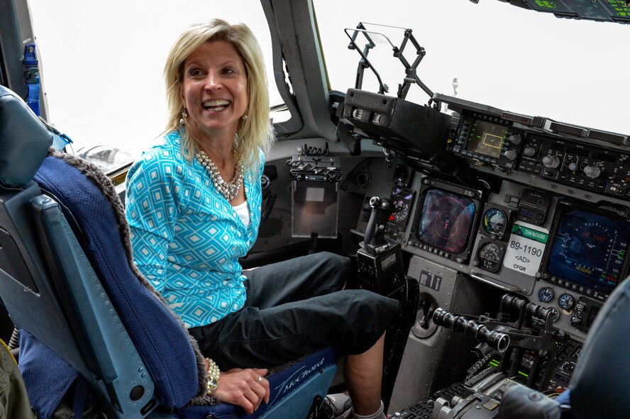 Madeline Lanza, I Corps senior spouse, takes a moment to experience sitting in the pilot seat of a C-17 Globemaster III aircraft June 12, 2014, at Joint Base Lewis-McChord, Wash. The I Corps Team of senior spouses were all able to speak with pilots from the 10th Airlift Squadron about their background flying the aircraft. (U.S. Air Force photo/Staff Sgt. Russ Jackson)