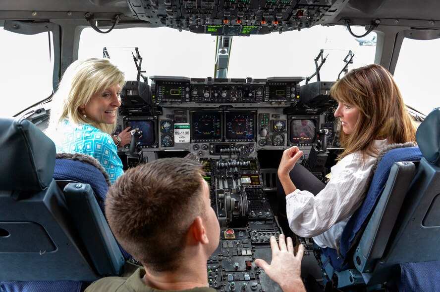 Capt. Shawn Rousseau, 10th Airlift Squadron pilot, discusses the training needed to become a C-17 Globemaster III pilot to Madeline Lanza (left) and Christy Shields (right), I Corps senior spouses June 12, 2014, at Joint Base Lewis-McChord, Wash. The purpose of their visit was to connect the I Corps Team of Teams in a military-centric setting to review the operational and expeditionary capacity of I Corps. (U.S. Air Force photo/Staff Sgt. Russ Jackson)