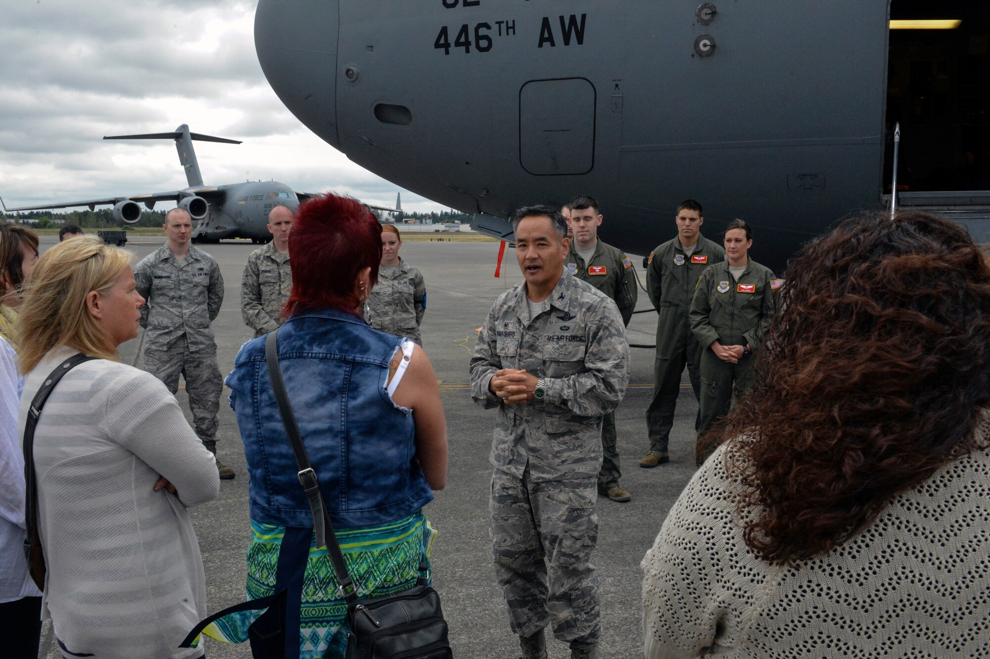 Col. David Kumashiro, 62nd Airlift Wing commander, explains the unique features of the C-17 Globemaster III aircraft to the I Corps Team of senior spouses June 12, 2014, at Joint Base Lewis-McChord, Wash. On their tour of McChord Field, the spouses received a Space A travel briefing at the McChord Field passenger terminal, a static C-17 tour and a tour of the USO facility. (U.S. Air Force photo/Staff Sgt. Russ Jackson)