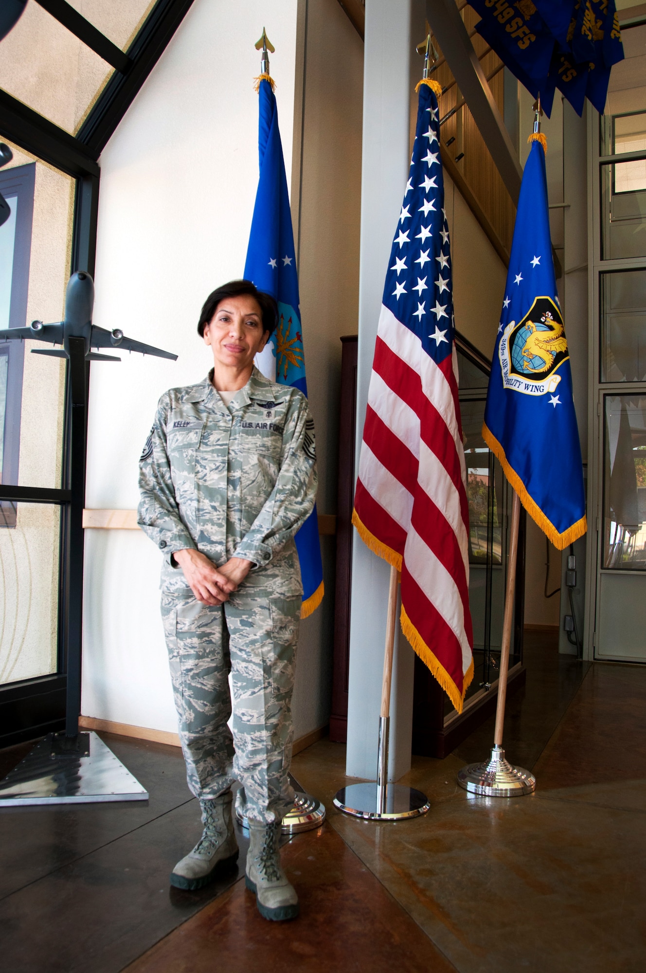 Chief Master Sgt. Ericka Kelly, 349th Air Mobility Wing command chief, stands in the entrance to the 349th wing command building June 9 on Travis Air Force Base, Calif.