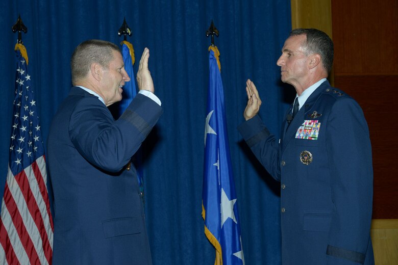 Gen. Robin Rand, commander of Air Education and Training Command, administers the Commissioned Officer Oath of Office to newly promoted Lt. Gen. Tony Rock during a promotion ceremony at Joint Base San Antonio-Randolph, Texas, June 19. Rock, a San Antonio native, called this opportunity to hold his promotion ceremony his hometown “unbelievably fortuitous.” (U.S. Air Force photo/Joel Martinez)