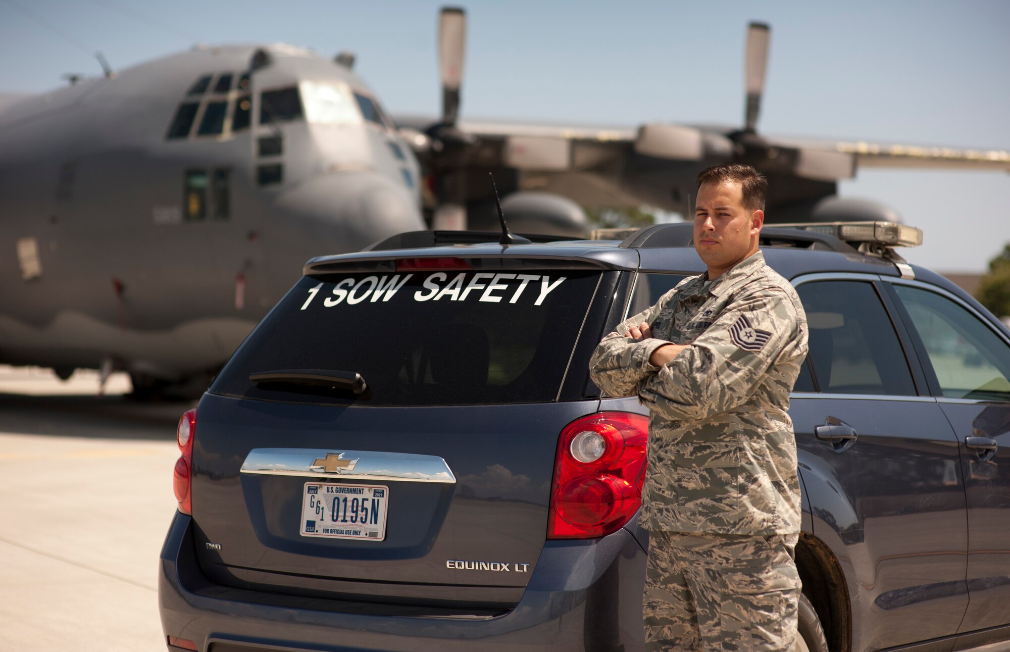 Tech. Sgt. Tony Peel, 1st Special Operations Wing flight safety NCO, poses in front of a safety vehicle and MC-130P Combat Shadow on the flightline at Hurlburt Field, Fla., June 18, 2014. Peel said mishap prevention is his main goal when performing safety spot checks on the flightline. (U.S. Air Force photo/Senior Airman Krystal M. Garrett) 