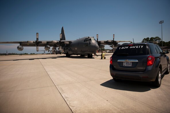 A safety vehicle sits in front of a MC-130P Combat Shadow on the flightline at Hurlburt Field, Fla., June 18, 2014. Tech. Sgt. Tony Peel, 1st Special Operations Wing flight safety NCO, roamed the flightline to ensure maintainers were using technical orders and wearing the proper personal protective equipment. (U.S. Air Force photo/Senior Airman Krystal M. Garrett)   