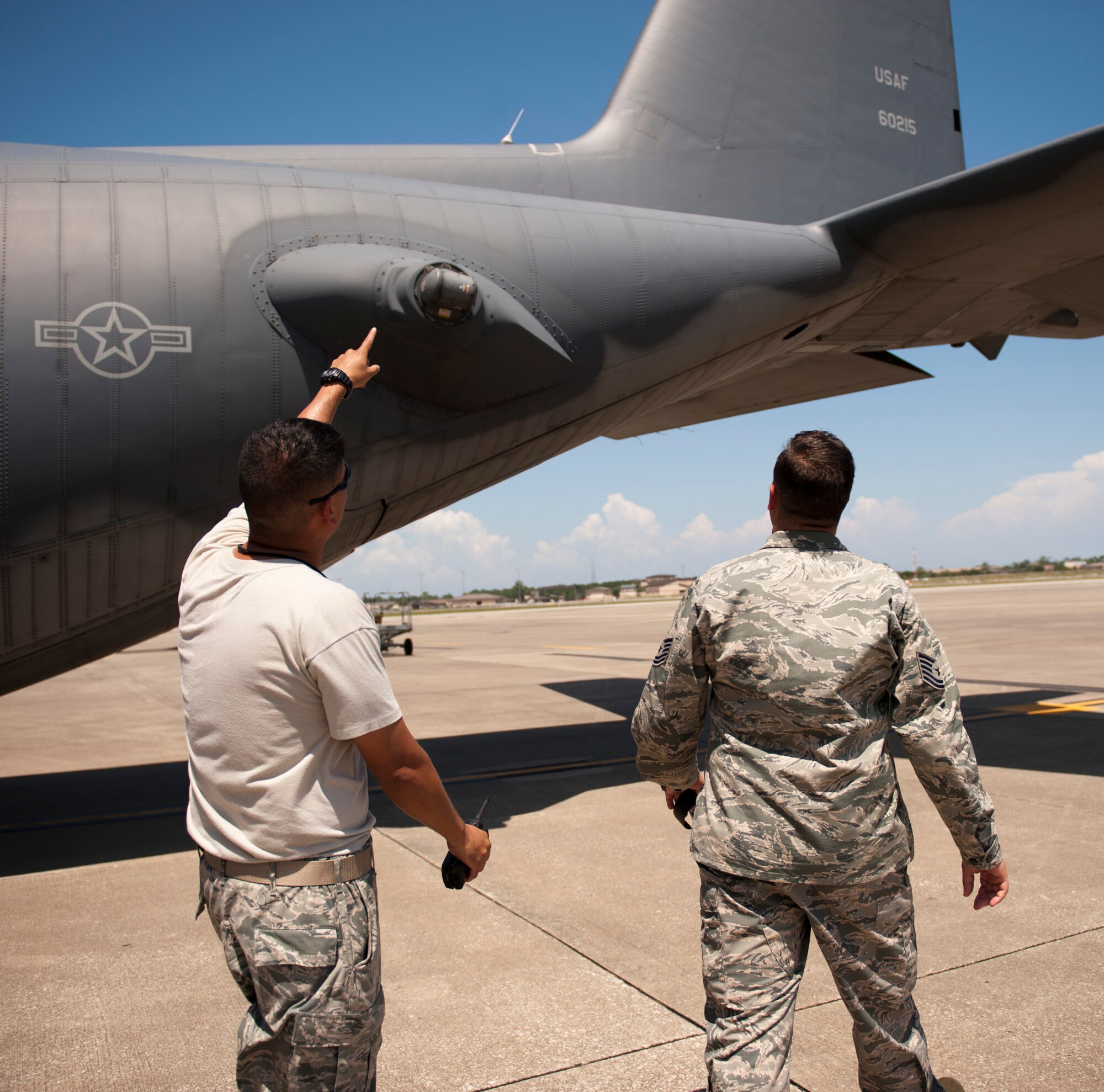 Tech. Sgt. Alfonso Ignacio, 901st Special Operations Aircraft Maintenance Squadron crew chief, points out a safety concern on an aircraft to Tech. Sgt. Tony Peel, 1st Special Operations Wing flight safety NCO, on the flightline at Hurlburt Field, Fla., June 18, 2014. Peel said he speaks to crew chiefs to address any safety concerns they may have. (U.S. Air Force photo/Senior Airman Krystal M. Garrett) 