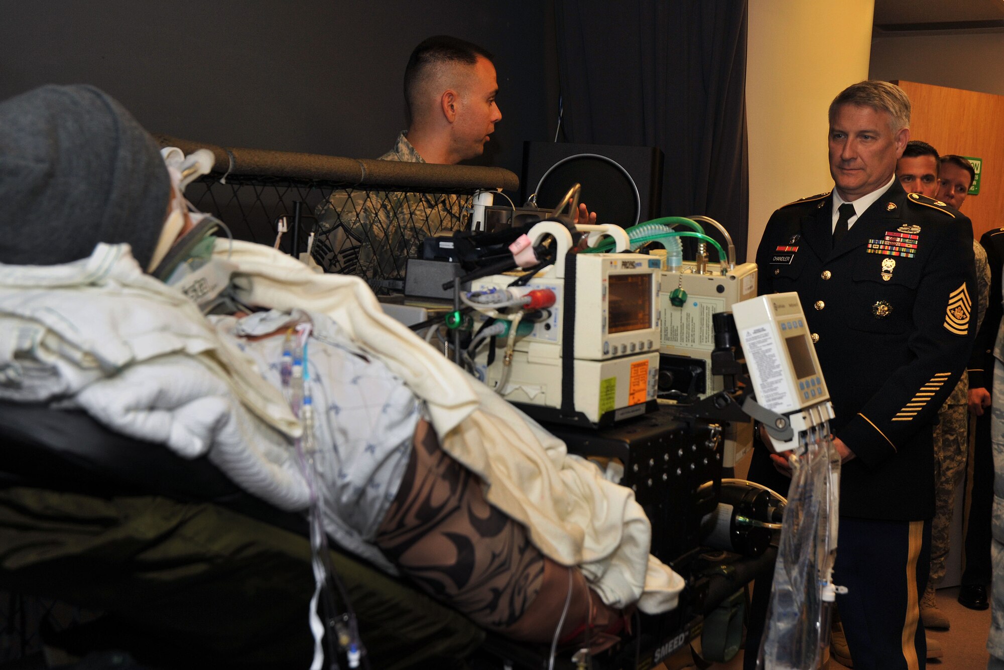 Sgt. James Woods, superintendent of the Center for Sustainment of Trauma and Readiness Skills in Cincinnati, explains to Sgt. Maj. of the Army, Raymond Chandler III the process of how the high-fidelity human patient simulator manikin can replicate any physiology they are going to see in their patients, while inside the Air Force’s CSTARS at the University Hospital, Cincinnati. This critical training allows students to experience the challenges of the austere environment and to improve medical crisis management skills (Air Force photo by Michelle Gigante).
