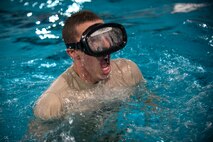 U.S. Air Force Cadet Phillip Fekaris surfaces from a water-confidence exercise called an underwater at Moody Air Force Base, Ga., June 17, 2014. The exercise involves swimming along the bottom of a pool for a specified distance. (U.S. Air Force photo by Senior Airman Jarrod Grammel/Released) 

