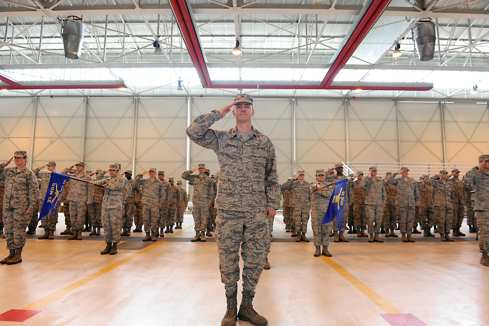 Col. Douglas Littlefield, 31st Medical Group deputy commander, renders a salute during the group’s change of command ceremony, June 20, 2014, at Aviano Air Base, Italy. Col. Linda Lawrence relinquished command of the group to Col. J. Scott Calder after three years of service to the 31st Fighter Wing. (U.S. Air Force photo/Airman 1st Class Ryan Conroy) 