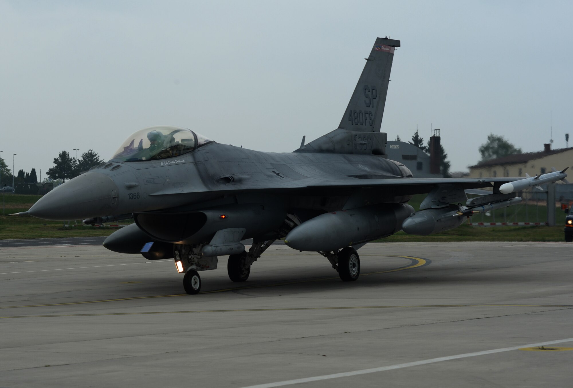 A 480th Fighter Squadron F-16 Fighting Falcon fighter aircraft pilot taxis on the flightline at Spangdahlem Air Base, Germany, May 2, 2014. The squadron sent aircraft and personnel to ensure a persistent NATO presence in Poland. Rotations of military aircraft and Airmen through the U.S. Air Force Aviation Detachment, 52nd Operations Group, Lask Air Base, Poland, began in late 2012, but were augmented in March as a deliberate effort to reassure allies of U.S. commitment and solidarity to collective defense. (U.S. Air Force photo illustration by Staff Sgt. Joe W. McFadden/Released)