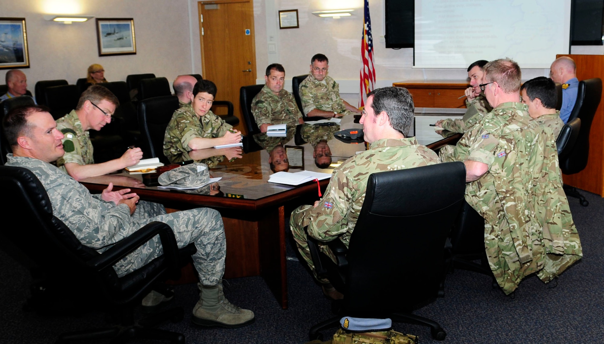 U.S. Air Force Col. Kenneth T. Bibb Jr., left, gives a mission brief to British military senior leaders, all students at the Defence Intelligence and Security Centre, RAF Chicksands, England, June 19, 2014, on RAF Mildenhall, England. As part of their attaché course, 19 students and one instructor from the DISC visited RAF Mildenhall and RAF Lakenheath to learn more about their U.S. Air Force allies. (U.S. Air Force photo/Karen Abeyasekere/Released)