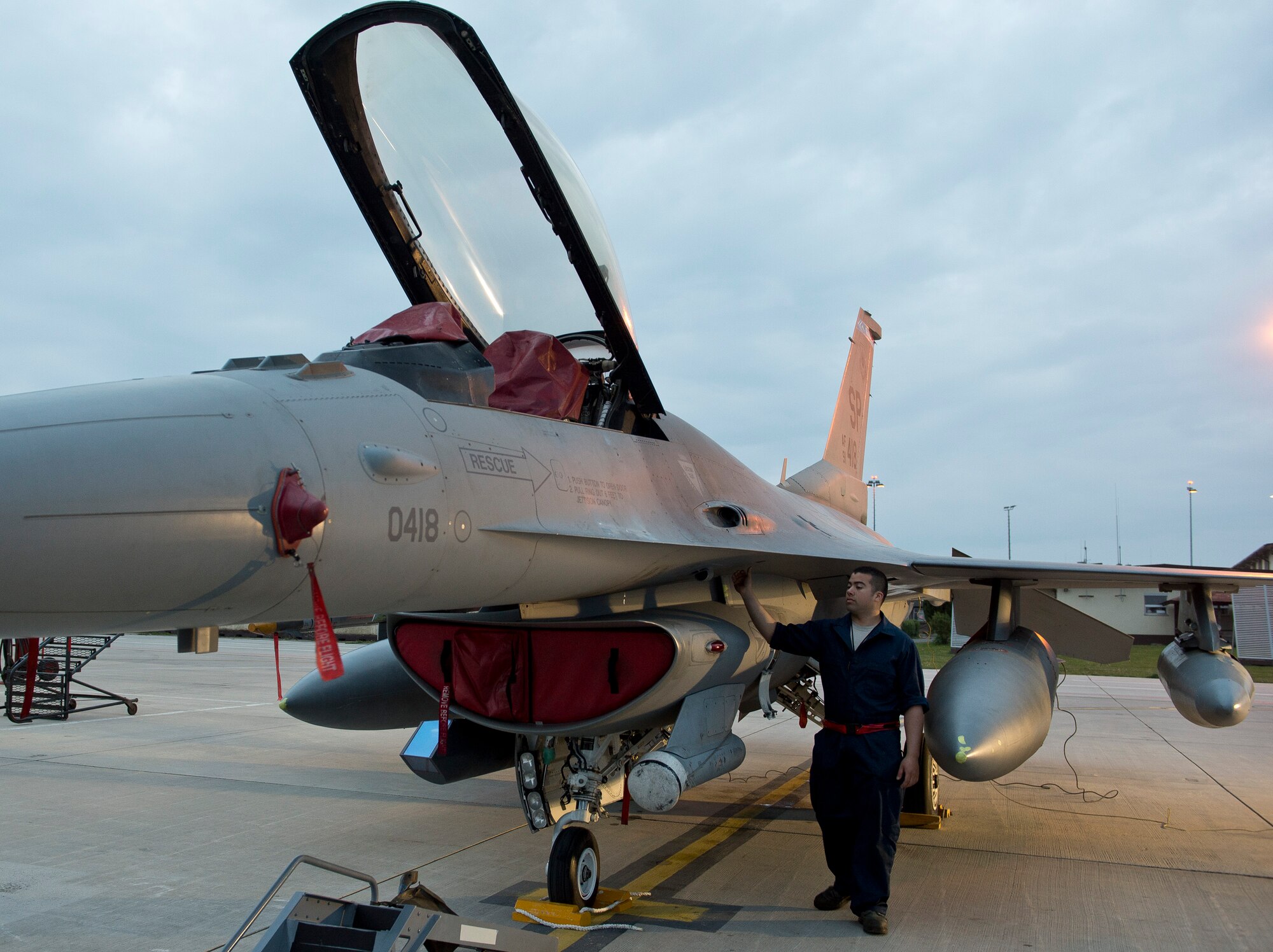 U.S. Air Force Senior Airman Miguel Dietrich, a 480th Aircraft Maintenance Unit crew chief from Independence, Calif., performs a pre-flight inspection on a U.S. Air Force F-16 Fighting Falcon fighter aircraft May 1, 2014, at Spangdahlem Air Base, Germany. 480th Fighter Squadron aircraft flew to Poland to enhance bilateral defense ties and give 52nd Fighter Wing aircrew and maintainers a chance to hone their skills alongside their Polish partners. (U.S. Air Force photo by Staff Sgt. Chad Warren/Released)