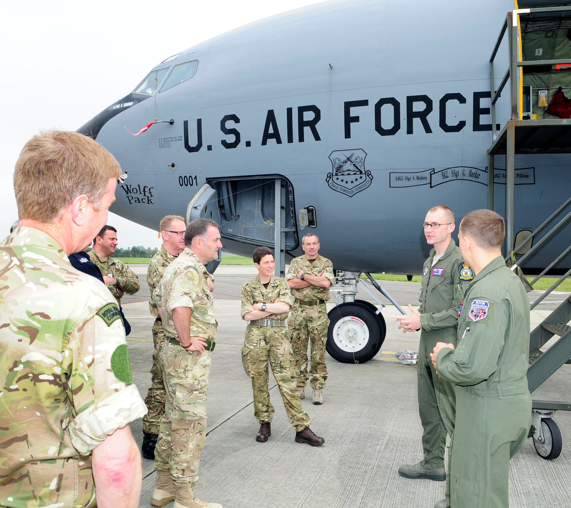 U.S. Air Force 1st Lt. David Holien, second from right, 351st Air Refueling Squadron pilot from Deadwood, S.D., and U.S. Air Force Senior Airman Eric Daschner, 351st ARS boom operator from Cleveland, talk about the KC-135 Stratotanker and the 100th Air Refueling Wing’s mission to students from the Defence Intelligence and Security Centre, RAF Chicksands, England, June 19, 2014, on RAF Mildenhall, England. As part of their attaché course, 19 students and one instructor visited RAF Mildenhall and RAF Lakenheath to learn more about their U.S. Air Force allies. (U.S. Air Force photo/Karen Abeyasekere/Released)