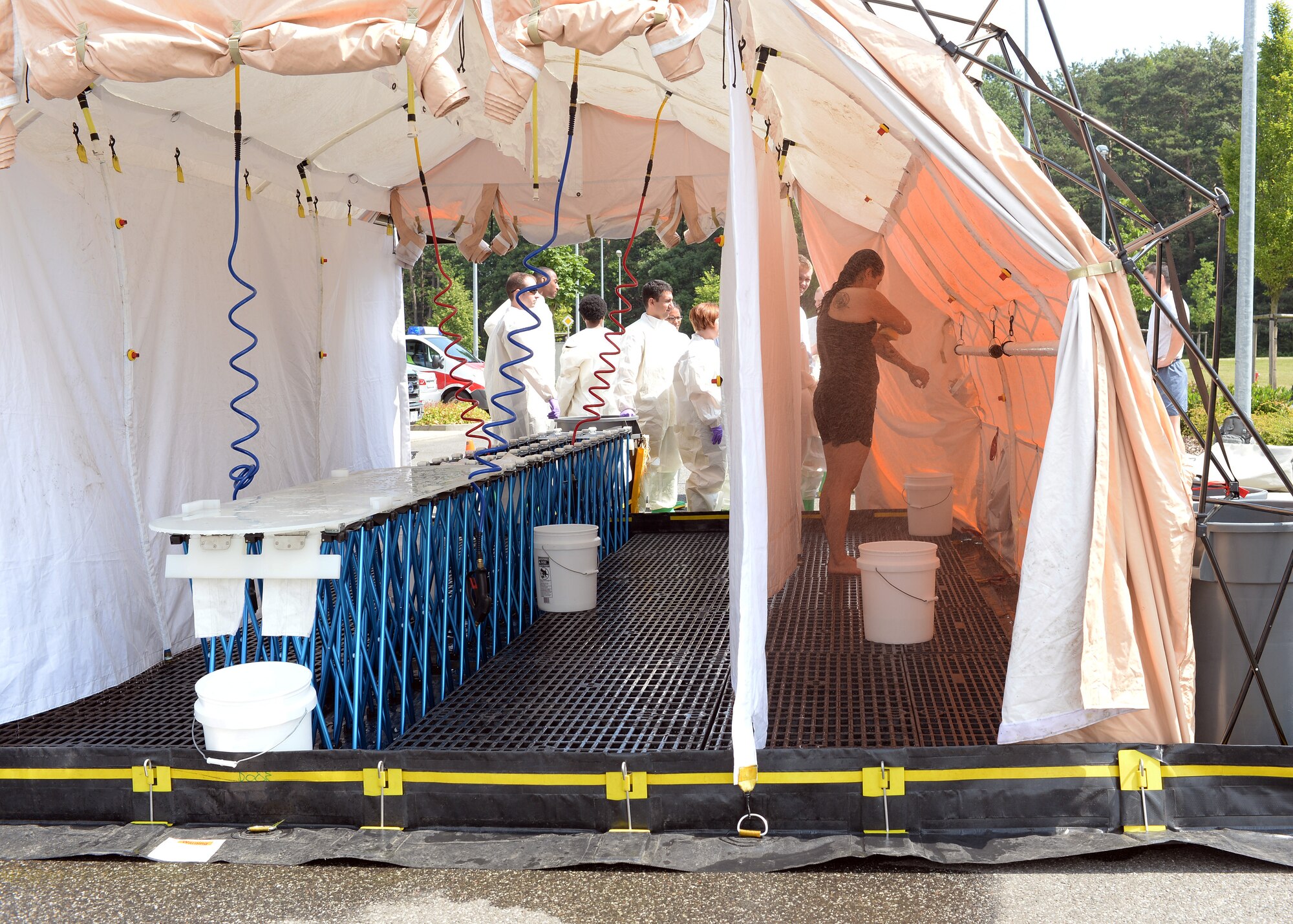 U.S. Air Force Staff Sgt. Ivonn Zepeda Chavez, 52nd Aerospace Medicine Squadron, volunteered as an ambulatory patient to go through the decontamination line during a training event June 18, 2014, at Spangdahlem Air Base, Germany. During a contamination crisis, people who are able to move can process through the line themselves. (U.S. Air Force photo by Staff Sgt. Daryl Knee/Released)