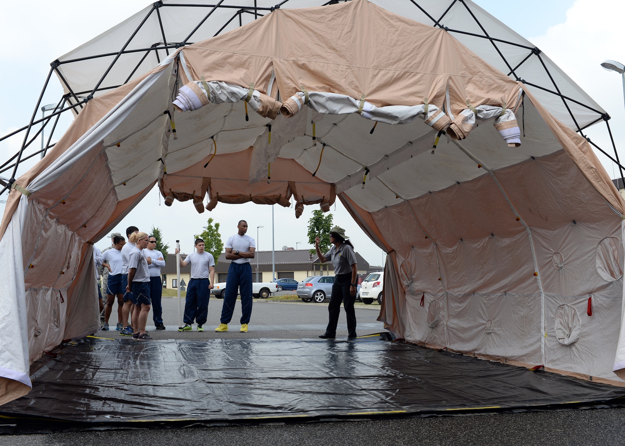 Theresa Casey, a senior instructor with the decontamination education and consulting company DECON, LLC, instructs a group of Airmen from throughout the 52nd Medical Group during a training event June 18, 2014, at Spangdahlem Air Base, Germany. More than 20 Airmen participated in the training to familiarize themselves with a mobile decontamination facility. (U.S. Air Force photo by Staff Sgt. Daryl Knee/Released)