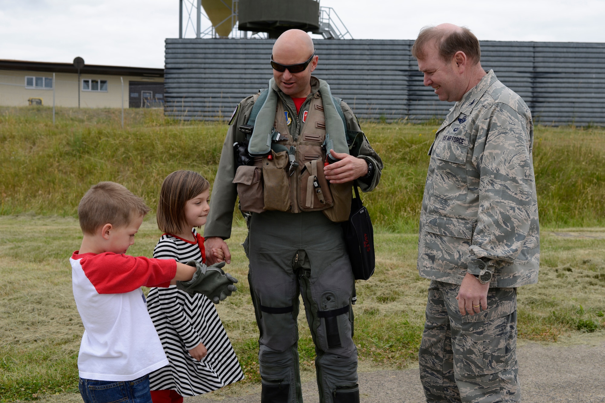 U.S. Air Force Col. Lars Hubert, acting 52nd Fighter Wing commander (right), greets U.S. Air Force Lt. Col. David Berkland, 480th Fighter Squadron commander, along with his children Mia and Matt after returning from U.S. Aviation Detachment Rotation 14-3, June 20, 2014, at Spangdahlem Air Base, Germany. U.S. Air Force pilots participated with multiple nations' air forces in Baltic Operations14, the largest annual maritime exercise in the Baltic region. Other nations participating in the exercise included Denmark, Estonia, France, Germany, Latvia, Lithuania and Sweden. (U.S. Air Force photo by Staff Sgt. Christopher Ruano/Released)