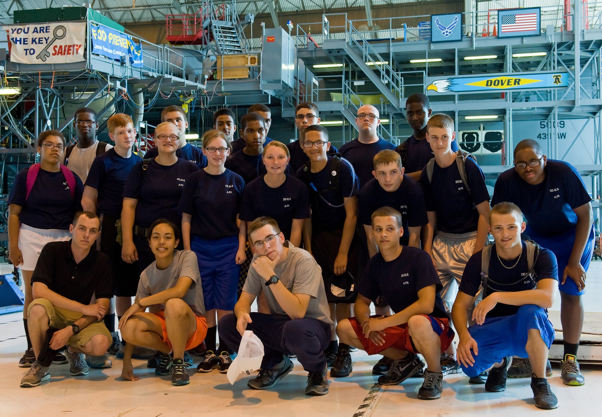 Air Force junior ROTC cadets pose for a photo June 18, 2014, inside the isochronal inspection hangar on Dover Air Force Base, Del. Seventy-four cadets from five Delaware high schools participated in a summer leadership school which included tours of Dover AFB facilities and aircraft. (U.S. Air Force photo/Roland Balik)