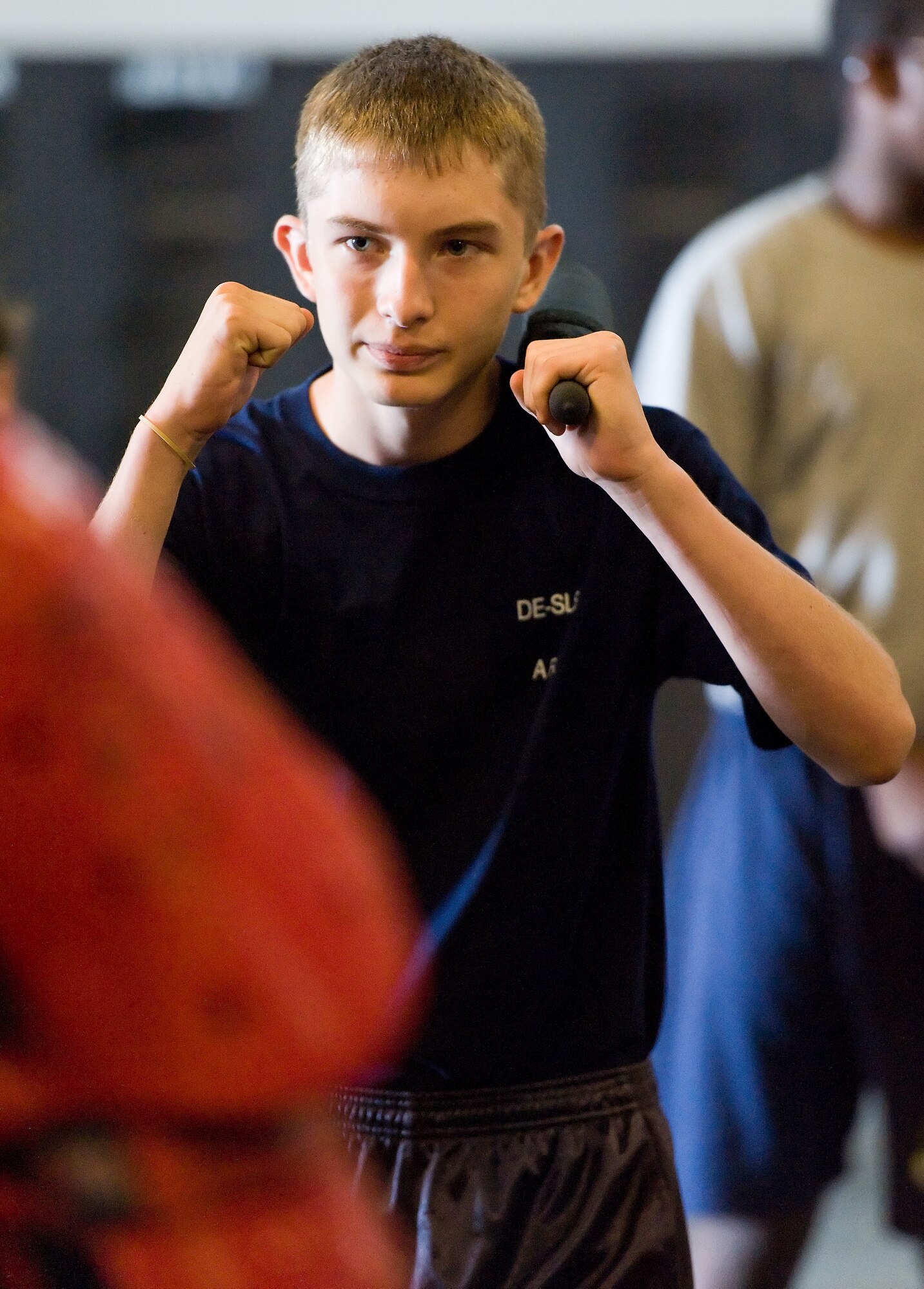 Air Force junior ROTC cadet John Colatriano, Middletown High School, Middletown, Del., prepares to battle June 18, 2014, at Dover Air Force Base, Del. Colatriano and other cadets took turns defending their position against the advances of a 436th Security Force Squadron Phoenix RAVEN during Armament Systems and Procedures collapsible baton training. (U.S. Air Force photo/Roland Balik)