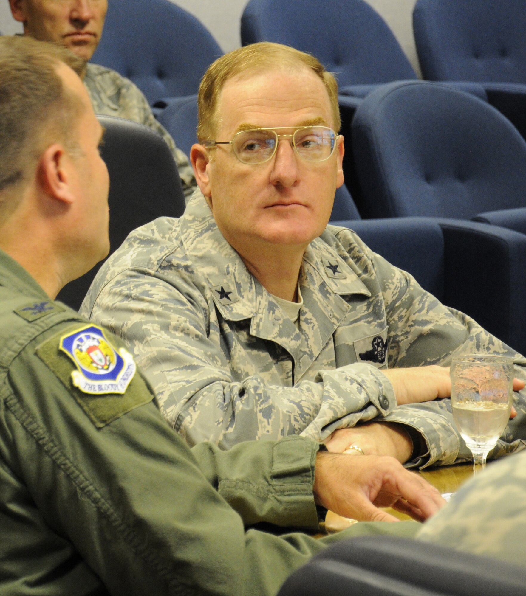 U.S. Air Force Brig. Gen. Douglas A. Cox, right, U.S. Air Forces in Europe-United Kingdom director, listens to a mission brief from U.S. Air Force Col. Kenneth T. Bibb Jr., 100th Air Refueling Wing commander, prior to a base tour June 20, 2014, on RAF Mildenhall, England. Cox met with Team Mildenhall leaders to learn their role in the mission. (U.S. Air Force photo/Gina Randall/Released)