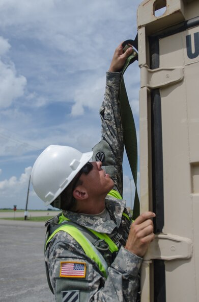 U.S. Army 1st Lt. Brandon Burimeister, clearance officer in charge for the 688th Rapid Port Opening Element, straps cargo to be transported to a staging area called the forward node during Capstone '14, a homeland earthquake-response exercise at Fort Campbell, Ky., on June 18, 2014. The Kentucky Air National Guard’s 123rd Contingency Response Group is joining with the 688th RPOE to operate a Joint Task Force-Port Opening here from June 16 to 19, 2014. (U.S. Air National Guard photo by Master Sgt. Phil Speck)