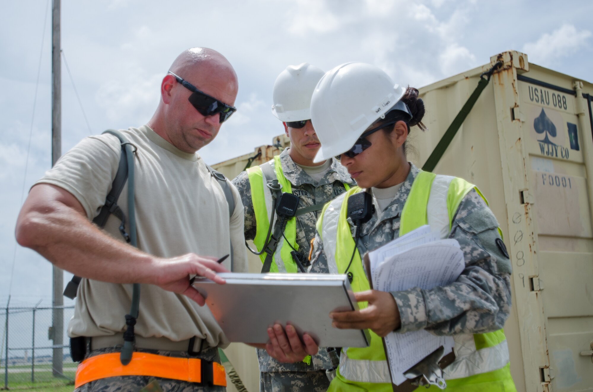 Sgt. Claribel Lopez Feliciano, yard boss for the U.S. Army’s 688th Rapid Port Opening Element, signs a manifest for cargo from Staff Sgt. Kevin Freese, an aerial porter for the Kentucky Air National Guard’s 123rd Contingency Response Group, before the cargo is shipped to a staging area called the forward node during Capstone '14, a homeland earthquake-response exercise at Fort Campbell, Ky., on June 18, 2014. The 123rd CRG is joining with the 688th RPOE to operate a Joint Task Force-Port Opening here from June 16 to 19, 2014. (U.S. Air National Guard photo by Master Sgt. Phil Speck)
