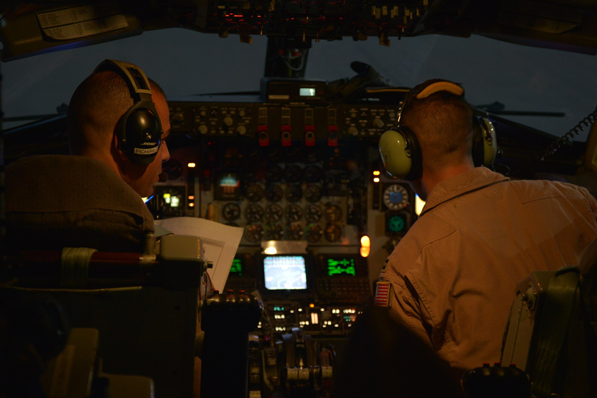 U.S. Air Force Maj. Kennan Pichirilo, left, and Capt. Benjamin Shamy, 340th Expeditionary Air Refueling Squadron KC-135 Stratotanker pilots, prepare for a flight for a refueling mission at Al Udeid Air Base, Qatar, June 20, 2014. The squadron is responsible for 60% of the fuel in U.S. Air Forces Central Command’s area of responsibility. (U.S. Air Force photo by Staff Sgt. Ciara Wymbs)