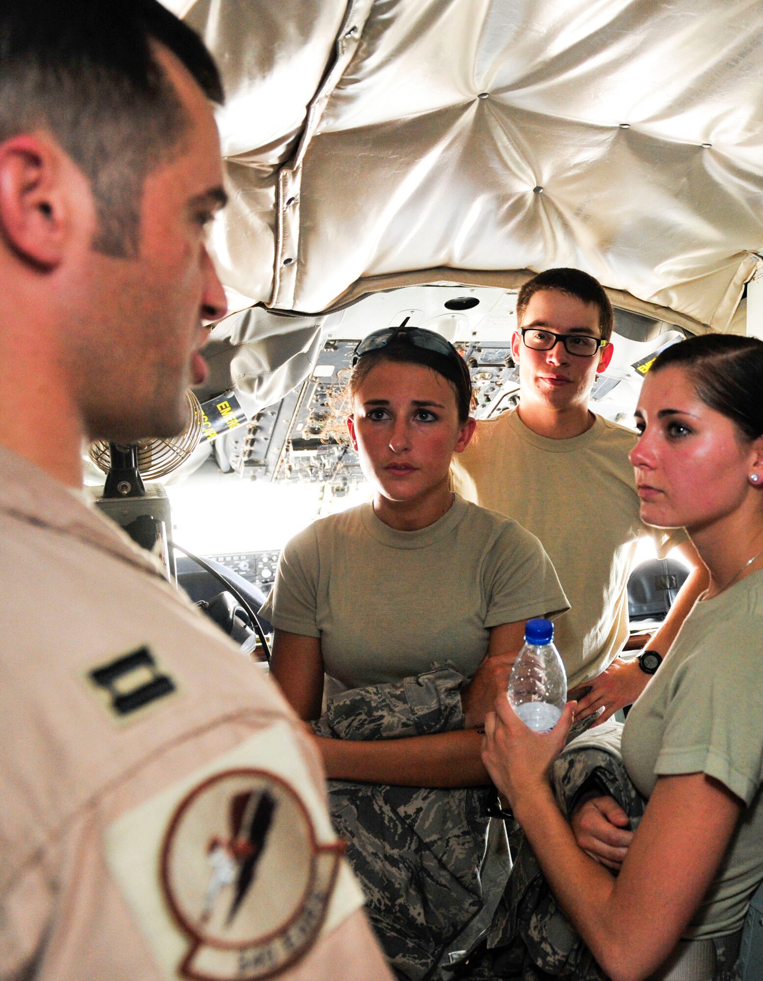 U.S. Air Force Capt. Harold Moss, 340th Air Refueling Squadron KC-135 pilot explains flight controls and general aircraft operations of the KC-135 Stratotanker to U.S. Air Force Academy cadets at Al Udeid Air Base, Qatar, June 16, 2014. The cadets are part a program called Operation Air Force, which gives them exposure to the operational side of the Air Force before being commissioned. Moss is deployed from MacDill Air Force Base, Florida. (U.S. Air Force photo by Senior Airman Colin Cates)