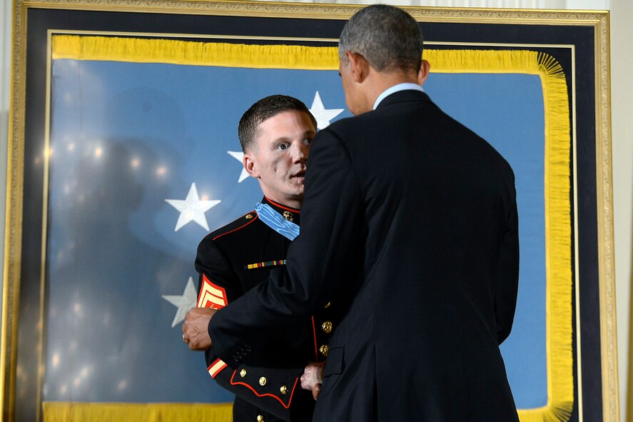 President Barack Obama awards the Medal of Honor to retired Marine Cpl. William "Kyle" Carpenter during a ceremony at the White House in Washington, D.C., June 19, 2014. Carpenter was recognized for his actions while deployed in Marjah, Helmand Province, Afghanistan, in 2010. He became the third Marine and the 15th overall recipient of the medal for actions in Iraq or Afghanistan. (DOD photo by EJ Hersom/Released)  
