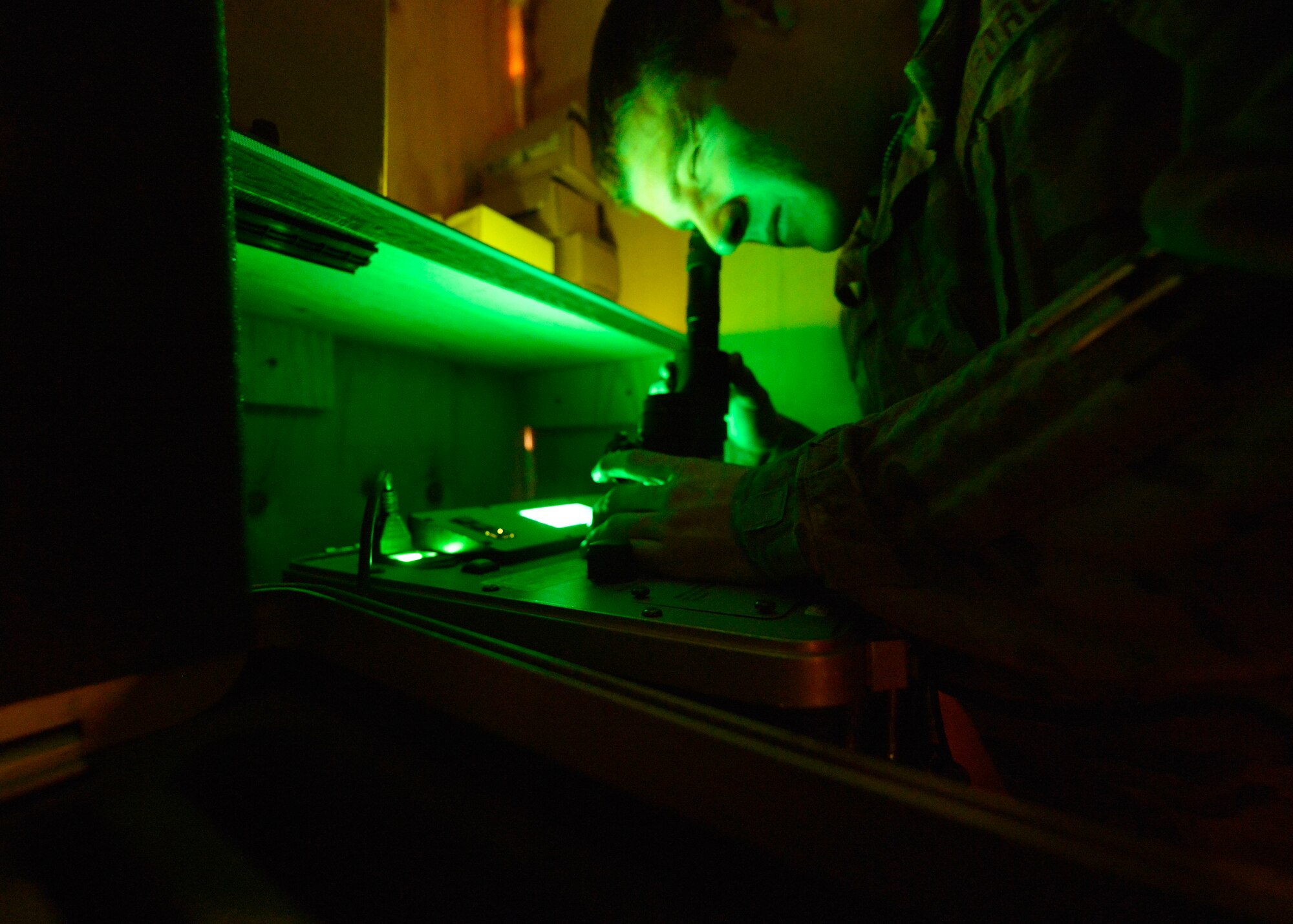 U.S. Air Force Senior Airman Zachary Moeller, 774th Expeditionary Airlift Squadron aircrew flight equipment specialist inspects night vision goggles at Bagram Airfield, Afghanistan June 18, 2014. As part of aircrew flight equipment, Moeller performs maintenance on all aircrew equipment, trains aircrew on equipment use and inspects their weapons before and after every mission. Moeller is deployed from Dyess Air Force Base, Texas and a native of Durango, Colo.  (U.S. Air Force photo by Staff Sgt. Evelyn Chavez/Released)
