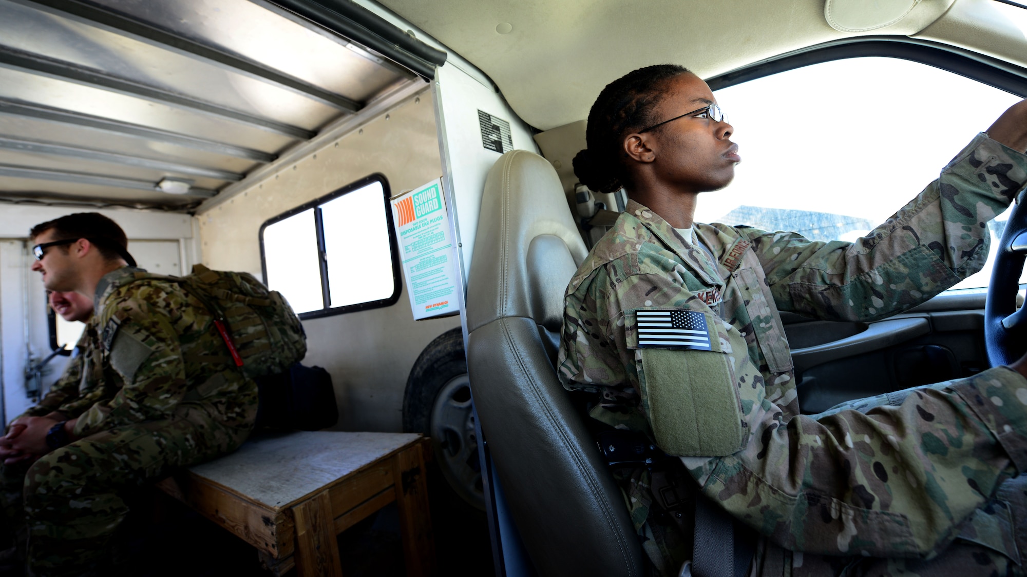U.S. Air Force Staff Sgt. Nancy Kendrick, 774th Expeditionary Airlift Squadron aircrew flight equipment non-commissioned officer-in-charge drives several pilots to their aircraft at Bagram Airfield, Afghanistan June 18, 2014. As part of aircrew flight equipment, Kendrick performs maintenance on all aircrew equipment, trains aircrew on equipment use and inspects their weapons before and after every mission. Kendrick is deployed from Dyess Air Force Base, Texas and a native of Philadelphia, Pa.  (U.S. Air Force photo by Staff Sgt. Evelyn Chavez/Released) 