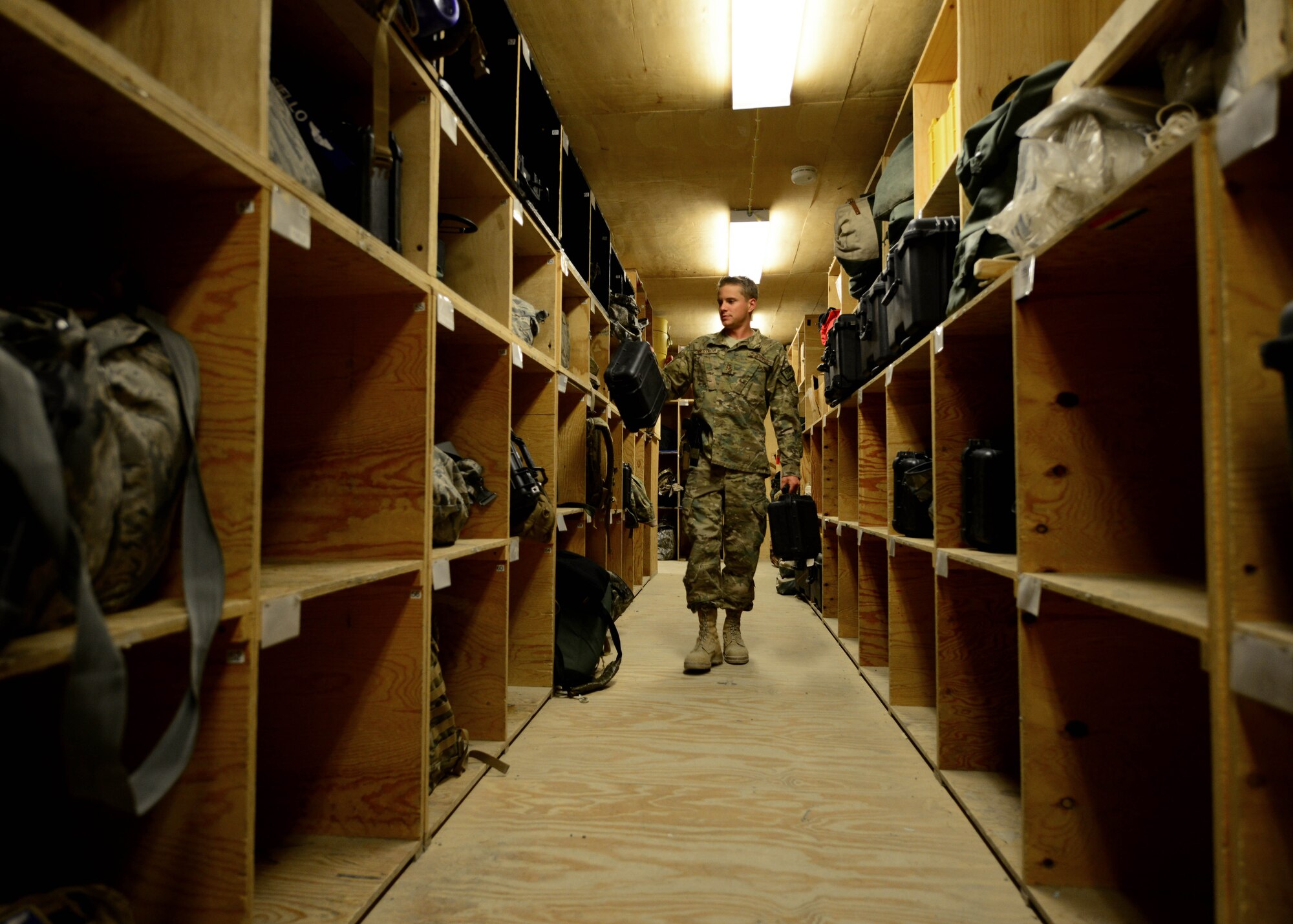 U.S. Air Force Senior Airman Ryan Jelstrom, 774th Expeditionary Airlift Squadron aircrew flight equipment specialist replaces aircrew equipment at Bagram Airfield, Afghanistan June 18, 2014. As part of aircrew flight equipment, Jelstrom and his team work 24-hours a day to ensure all aircrew equipment is serviceable for C-130J Super Hercules aircraft here. Jelstrom is deployed from Dyess Air Force Base, Texas and a native of Cayucos, Calif.  (U.S. Air Force photo by Staff Sgt. Evelyn Chavez/Released)