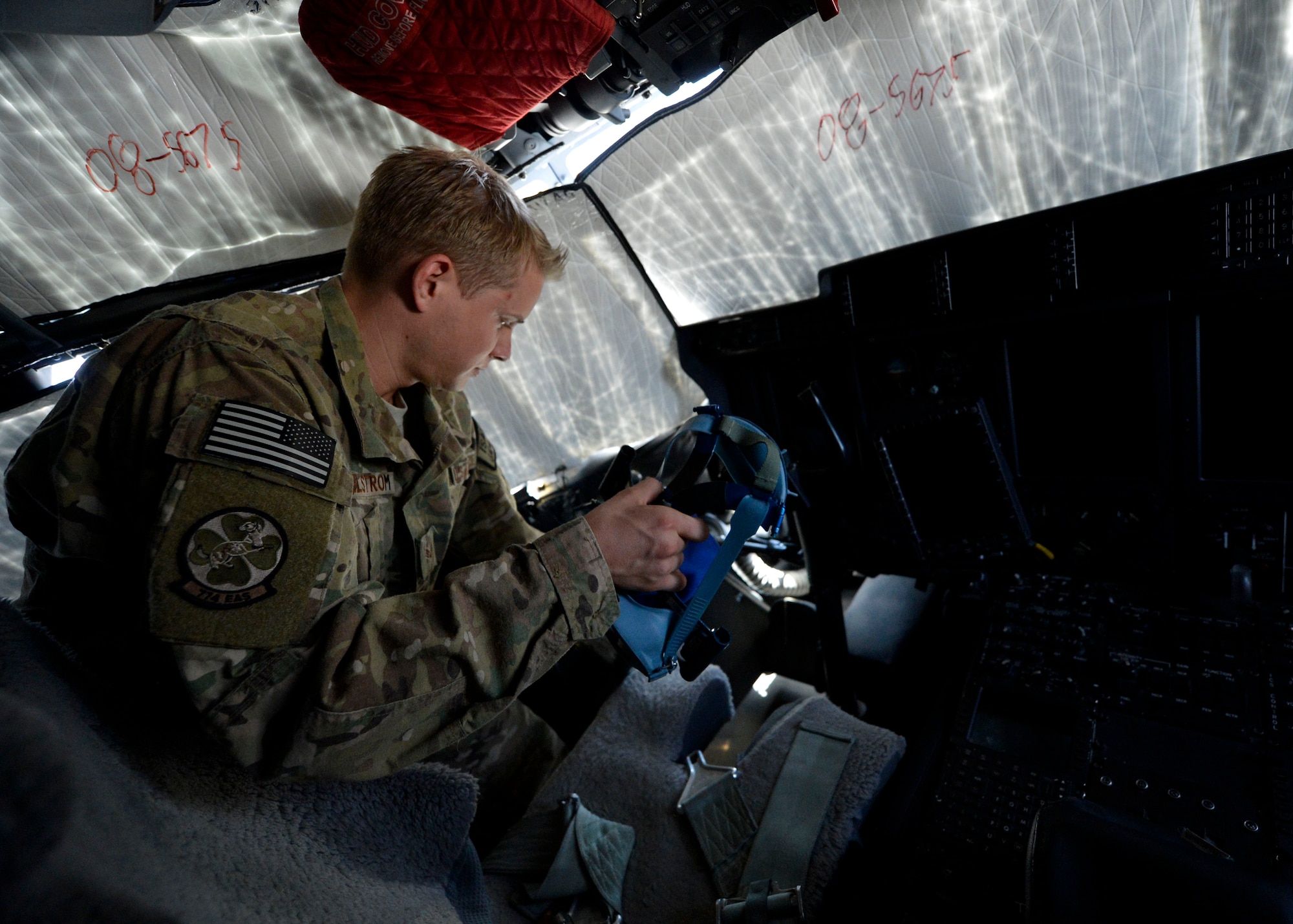 U.S. Air Force Senior Airman Ryan Jelstrom, 455th Operations Group aircrew flight equipment specialist inspects a pilot’s oxygen mask on a C-130J Super Hercules at Bagram Airfield, Afghanistan June 18, 2014.  As part of aircrew flight equipment, Jelstrom is responsible for ensuring aircrew equipment such as helmets, oxygen masks, parachutes and night vision goggles are serviceable for every mission. Jelstrom is deployed from Dyess Air Force Base, Texas and a native of Cayucos, Calif.  (U.S. Air Force photo by Staff Sgt. Evelyn Chavez/Released)