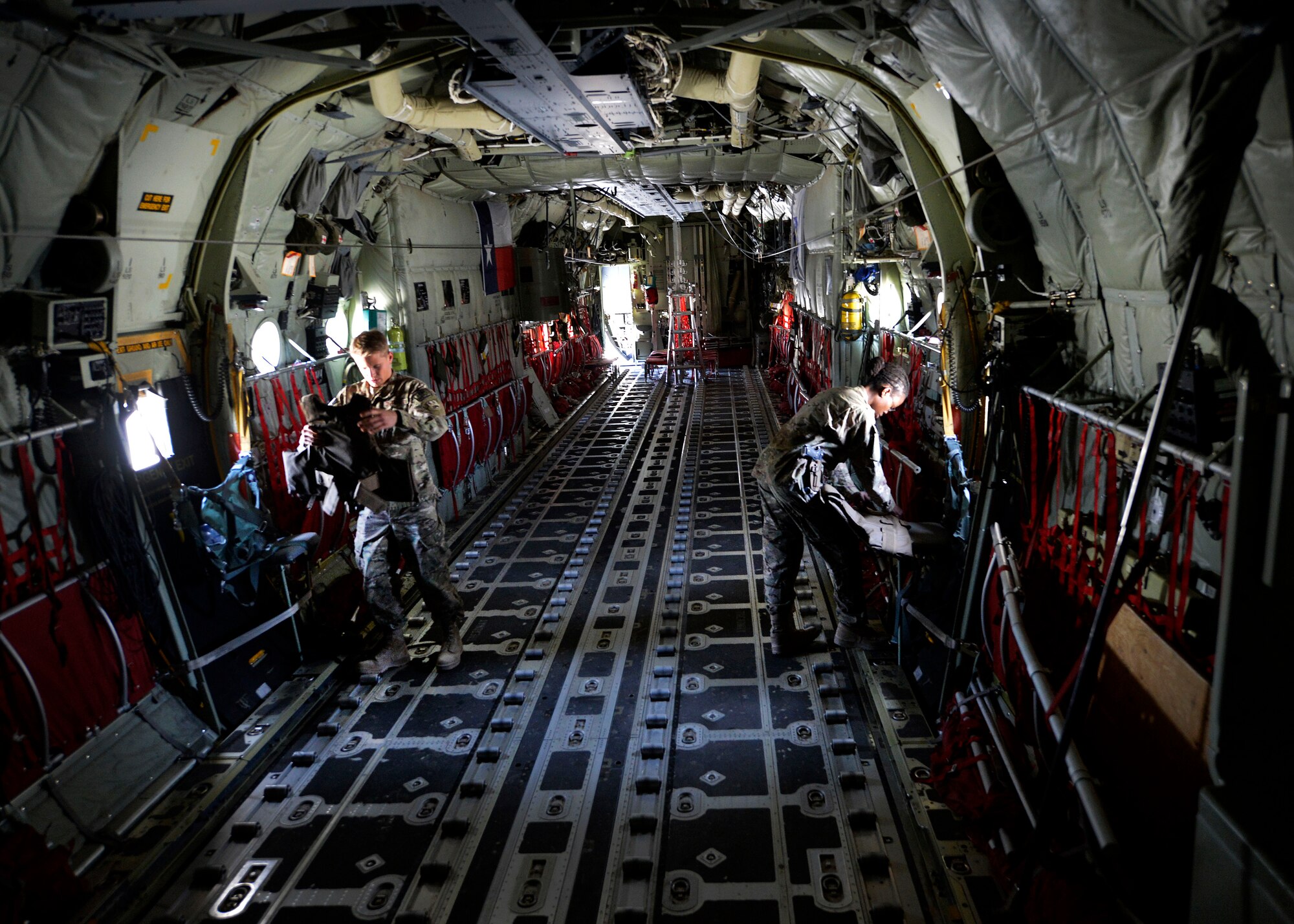 (From left) U.S. Air Force Senior Airman Ryan Jelstrom, 774th Expeditionary Airlift Squadron aircrew flight equipment specialist and Staff Sgt. Nancy Kendrick, aircrew flight equipment non-commissioned officer-in-charge inspect aircrew body armor on a C-130J Super Hercules at Bagram Airfield, Afghanistan June 18, 2014.  As part of aircrew flight equipment, they are responsible for ensuring aircrew equipment such as helmets, oxygen masks, parachutes and night vision goggles are serviceable for every mission. Jelstrom is deployed from Dyess Air Force Base, Texas and a native of Cayucos, Calif.  Kendrick is deployed from Dyess Air Force Base, Texas and a native of Philadelphia, Pa.  (U.S. Air Force photo by Staff Sgt. Evelyn Chavez/Released)