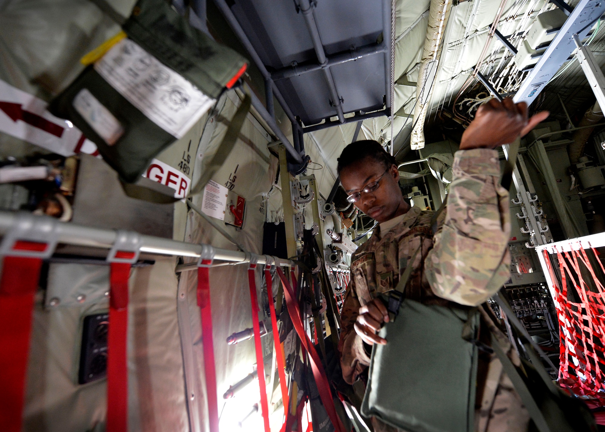 U.S. Air Force Staff Sgt. Nancy Kendrick, 774th Expeditionary Airlift Squadron aircrew flight equipment non-commissioned officer-in-charge removes emergency passenger oxygen systems from a C-130J Super Hercules at Bagram Airfield, Afghanistan June 18, 2014.  As part of aircrew flight equipment, Kendrick is responsible for ensuring aircrew equipment such as helmets, oxygen masks, parachutes and night vision goggles are serviceable for every mission. Kendrick is deployed from Dyess Air Force Base, Texas and a native of Philadelphia, Pa.  (U.S. Air Force photo by Staff Sgt. Evelyn Chavez/Released)
