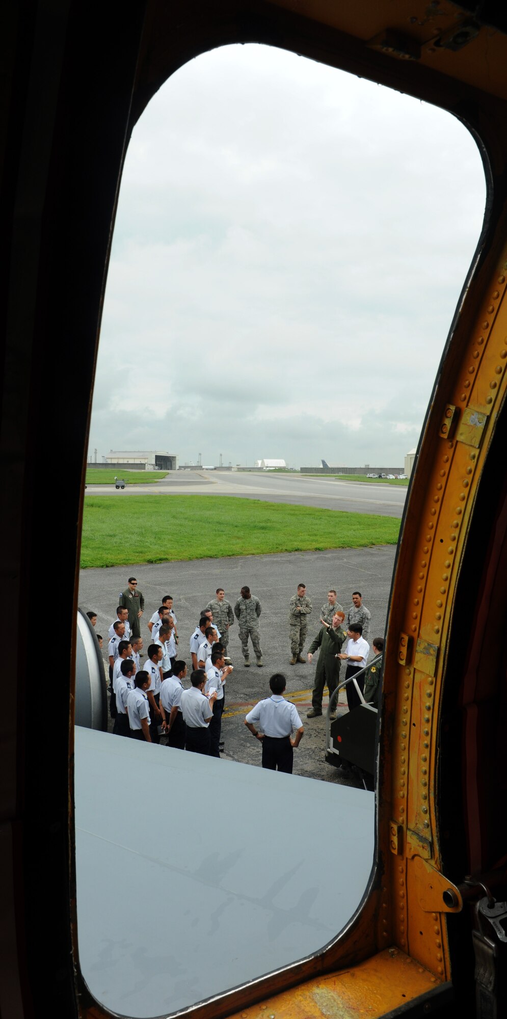 Members of the Japan Air Self Defense Force tour a static display of a KC-135 Stratotanker on Kadena Air Base, Japan, June 19, 2014. More than 80 members visited Kadena to learn more about Kadena's mission and capabilities by briefings, static display and a windshield tour of the base. (U.S. Air Force photo by Airman 1st Class Keith James)