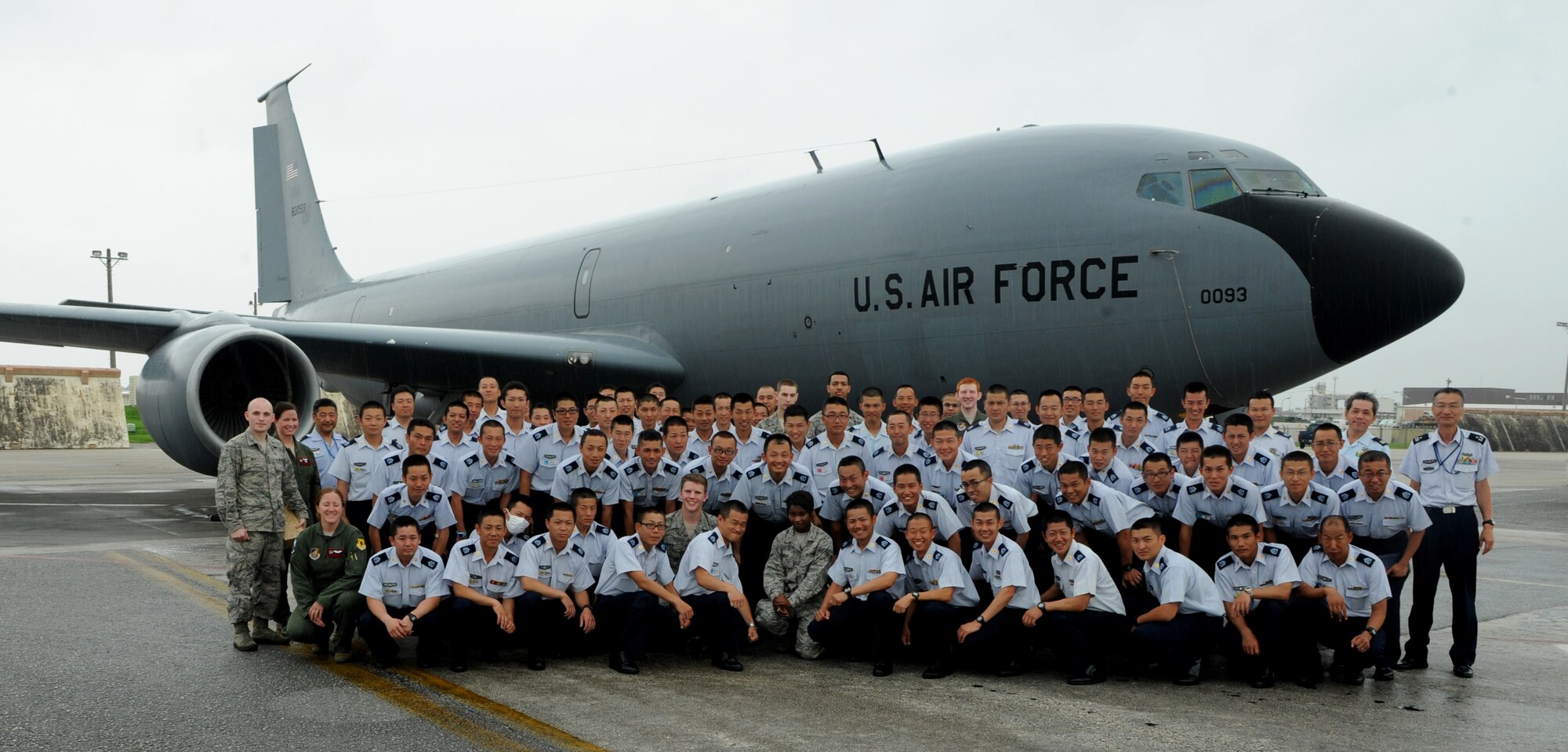 Members of the Japan Air Self Defense Force and 909th Air Refueling Squadron take a group photo next to a U.S. Air Force KC-135 Stratotanker during a tour on Kadena Air Base, Japan, June 19, 2014. During the tour more than 80 JASDF members visited Kadena to learn more about the base's mission and capabilities. (U.S. Air Force photo by Airman 1st Class Keith James)